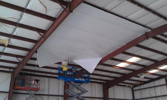 Retroshield being installed onto a ceiling