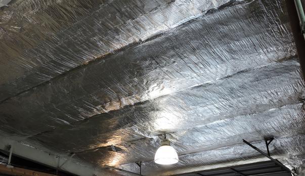 a ceiling insulated with reflective foam with a light on it