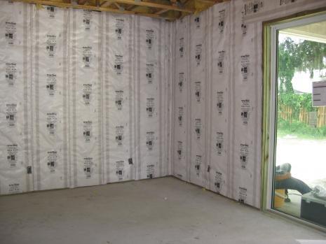 a room with a glass door and a wall covered in VR Plus shield insulation